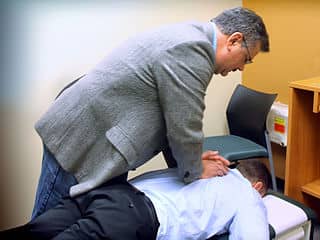person in chiropractic session, Chiropractor can help, first visit